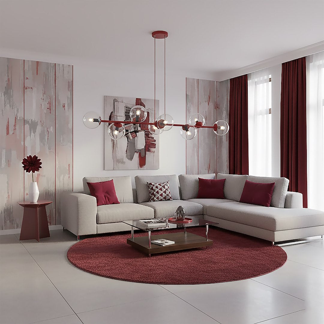 Mise en ambiance séjour avec canapé d'angle beige, tapis rond bordeaux et tableaux