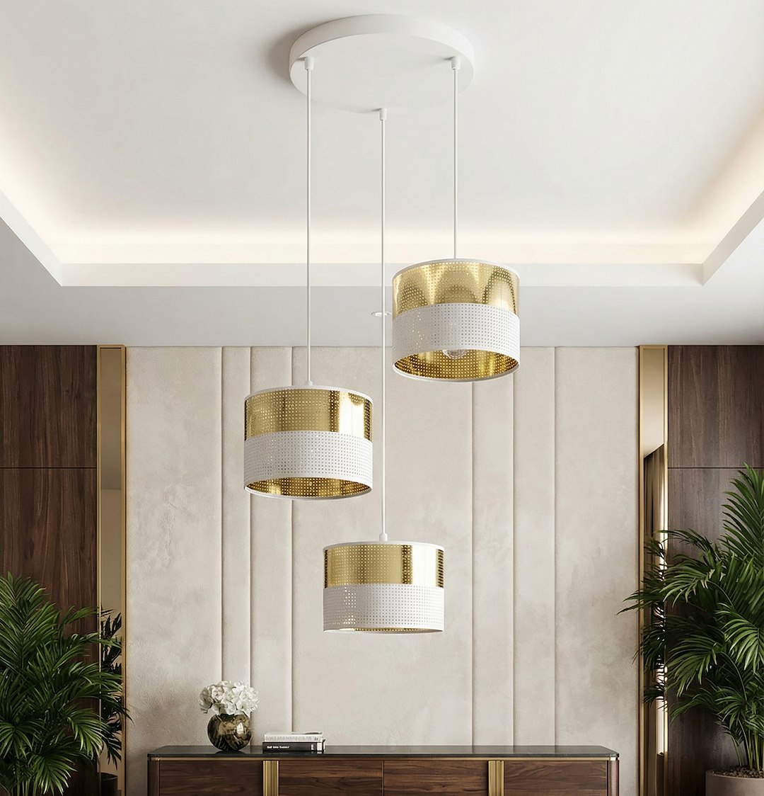 Mise en ambiance au-dessus d'un buffet avec plantes, suspension dorée et blanche allumée.