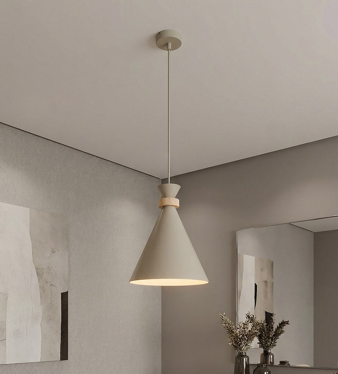 Vue en plongée sous plafond, suspension allumée devant miroir et vase à fleurs séchées
