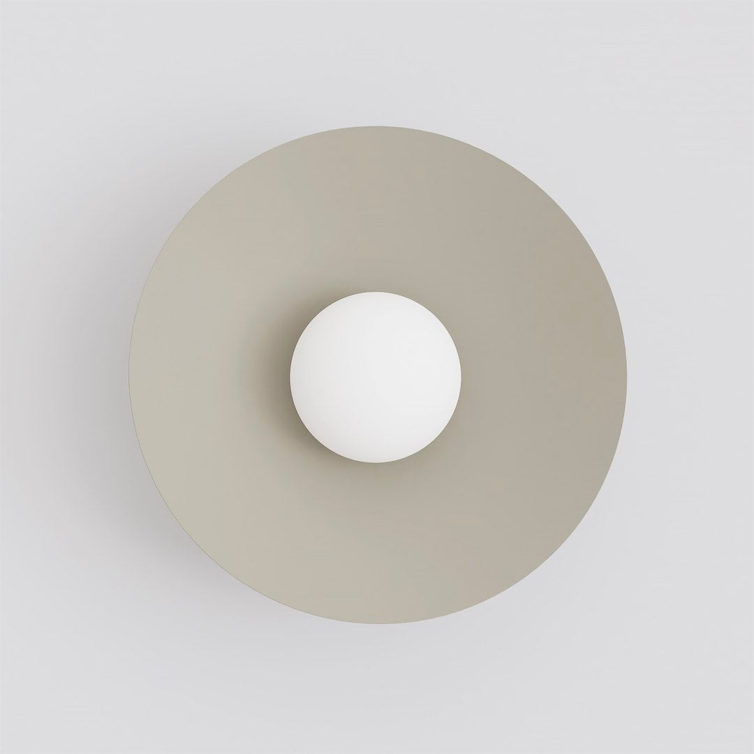 Vue de face montrant le disque beige et la sphère lumineuse blanche