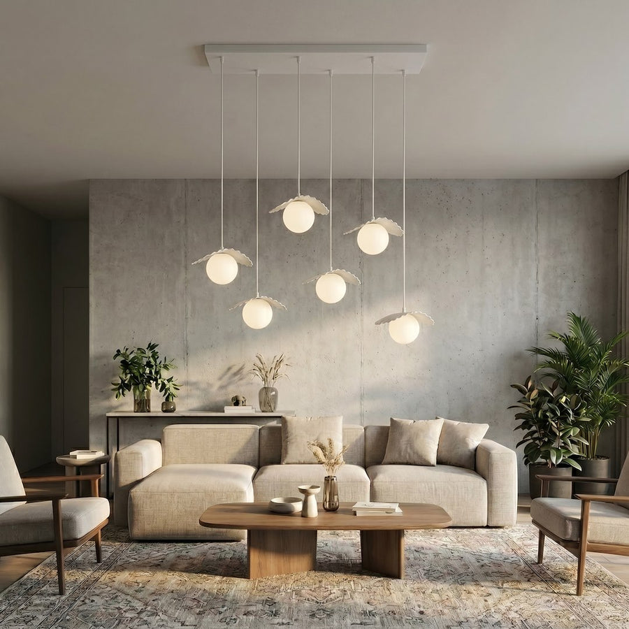 Mise en ambiance salon béton avec canapé beige et suspensions allumées