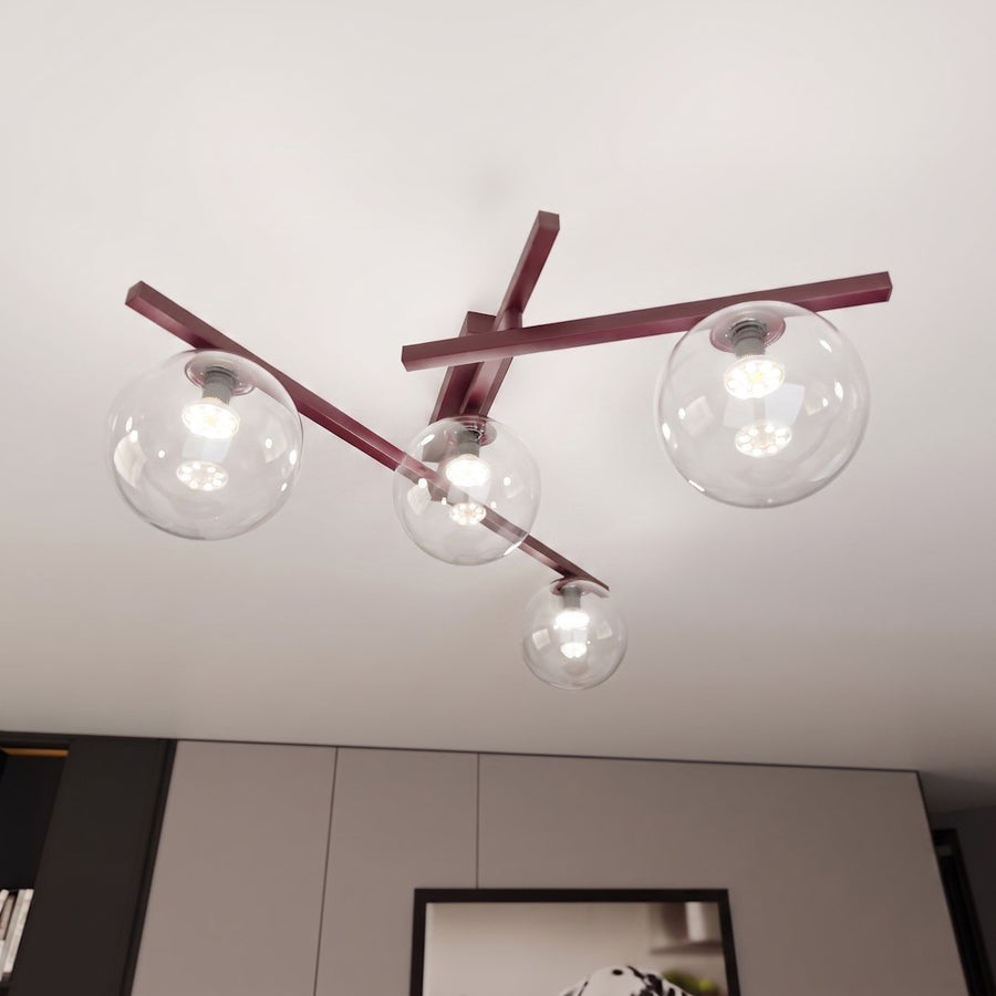 Vue en contre-plongée du luminaire fixé au plafond, globes allumés et bras bordeaux.
