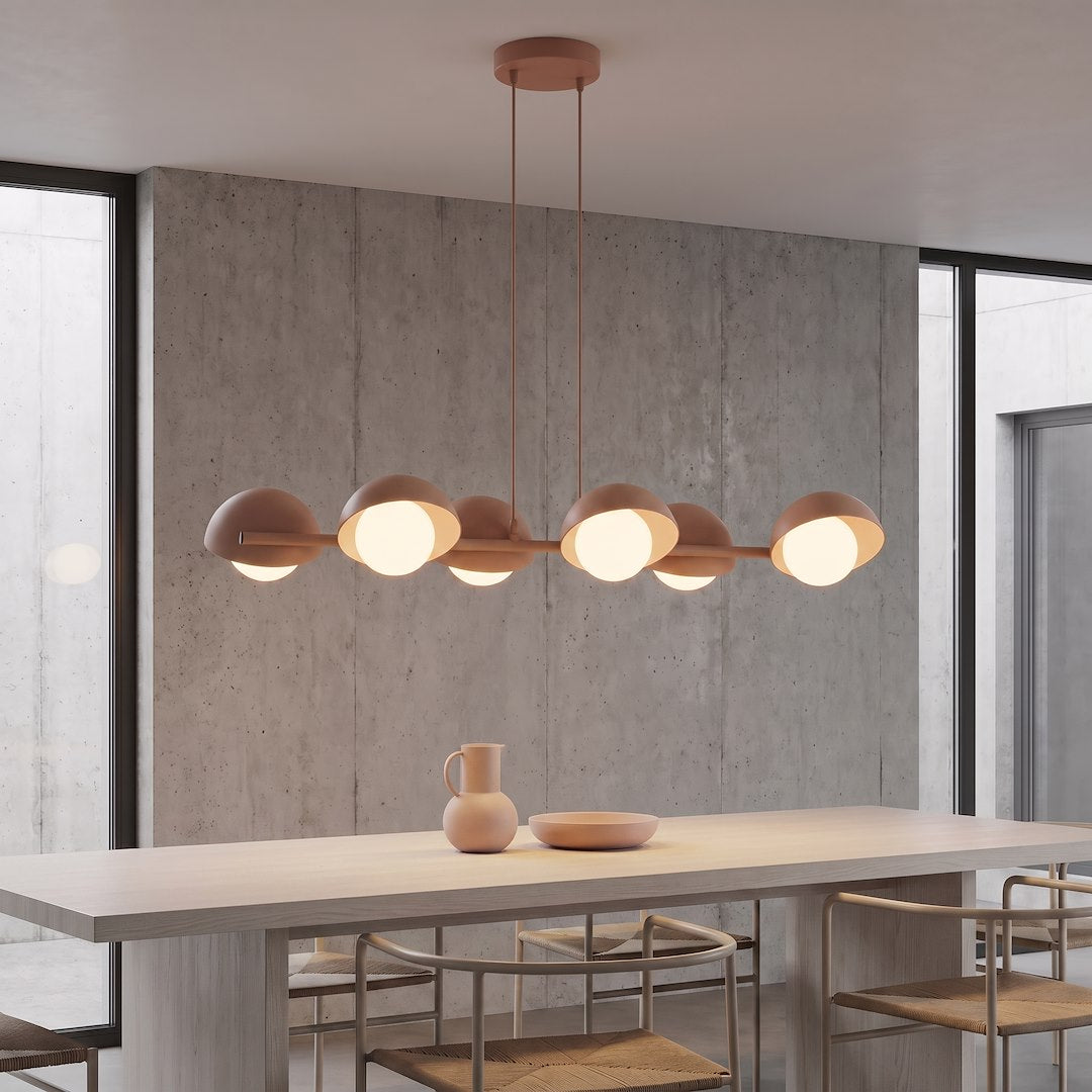 Suspension installée au-dessus d'une table en bois, dans une salle à manger béton.