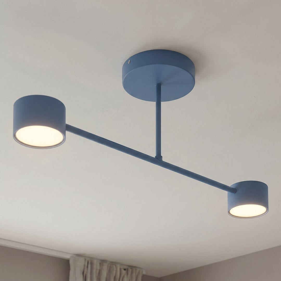 Luminaire bleu installé au plafond, lumière allumée éclairant la pièce