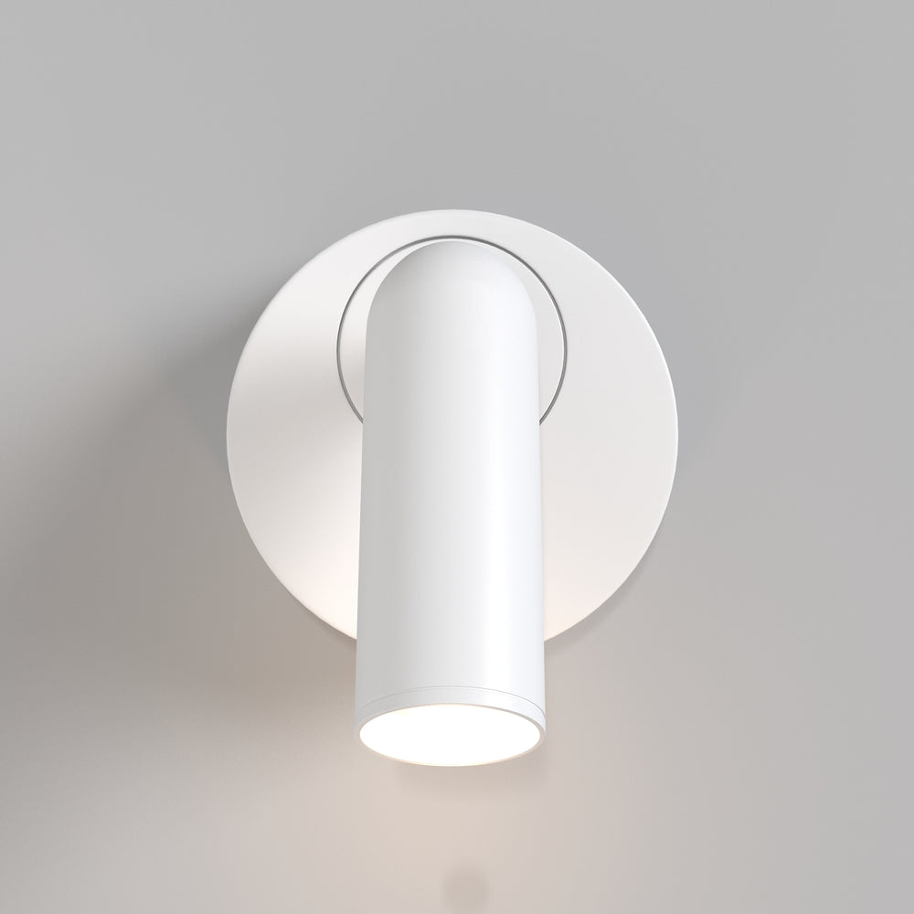 Vue rapprochée du projecteur cylindrique blanc allumé sur sa platine ronde