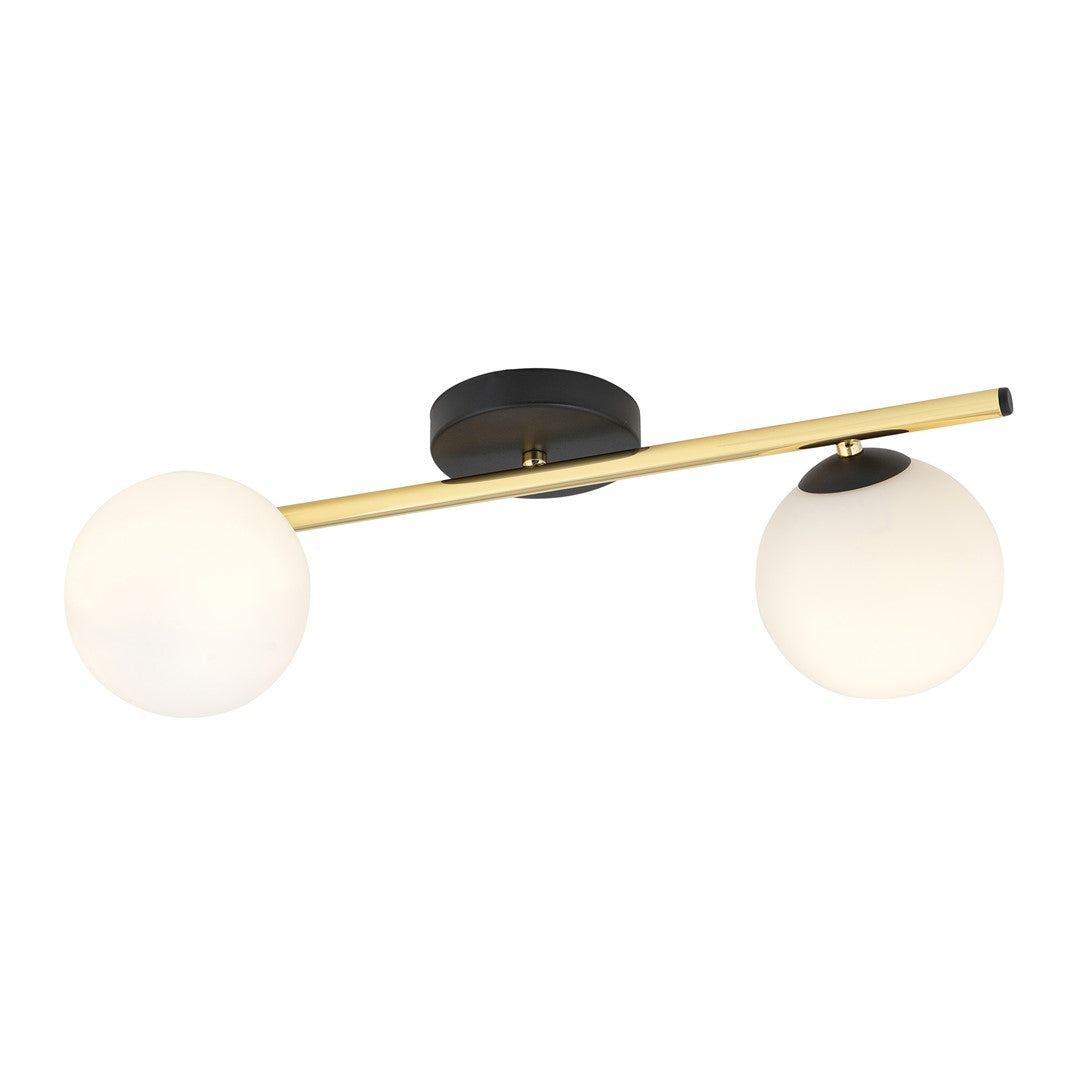 Même luminaire allumé, globes de verre opale diffusant une lumière chaude et douce