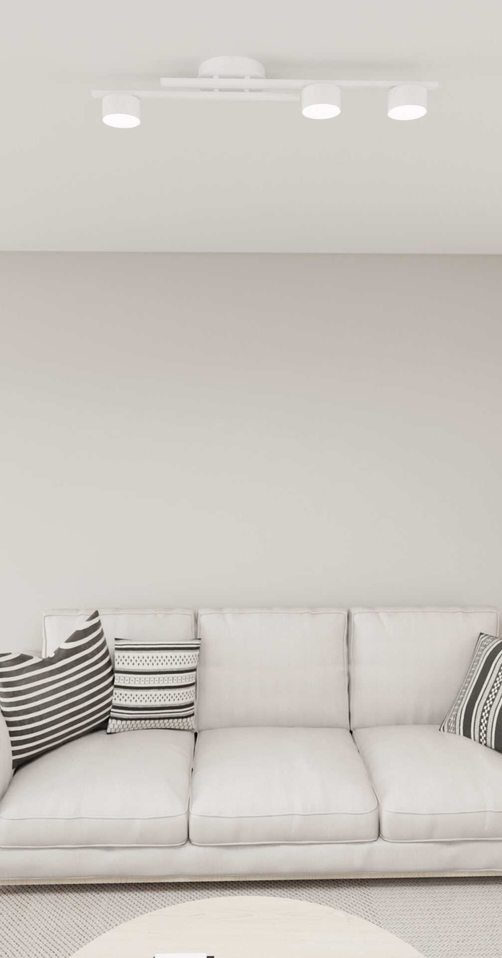 Vue rapprochée plafond montrant les trois spots allumés au-dessus du canapé