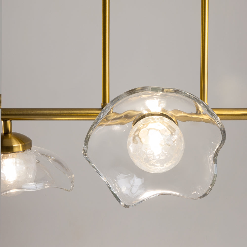 Gros plan sur un abat-jour en verre ondulé transparent et ampoule centrale allumée.