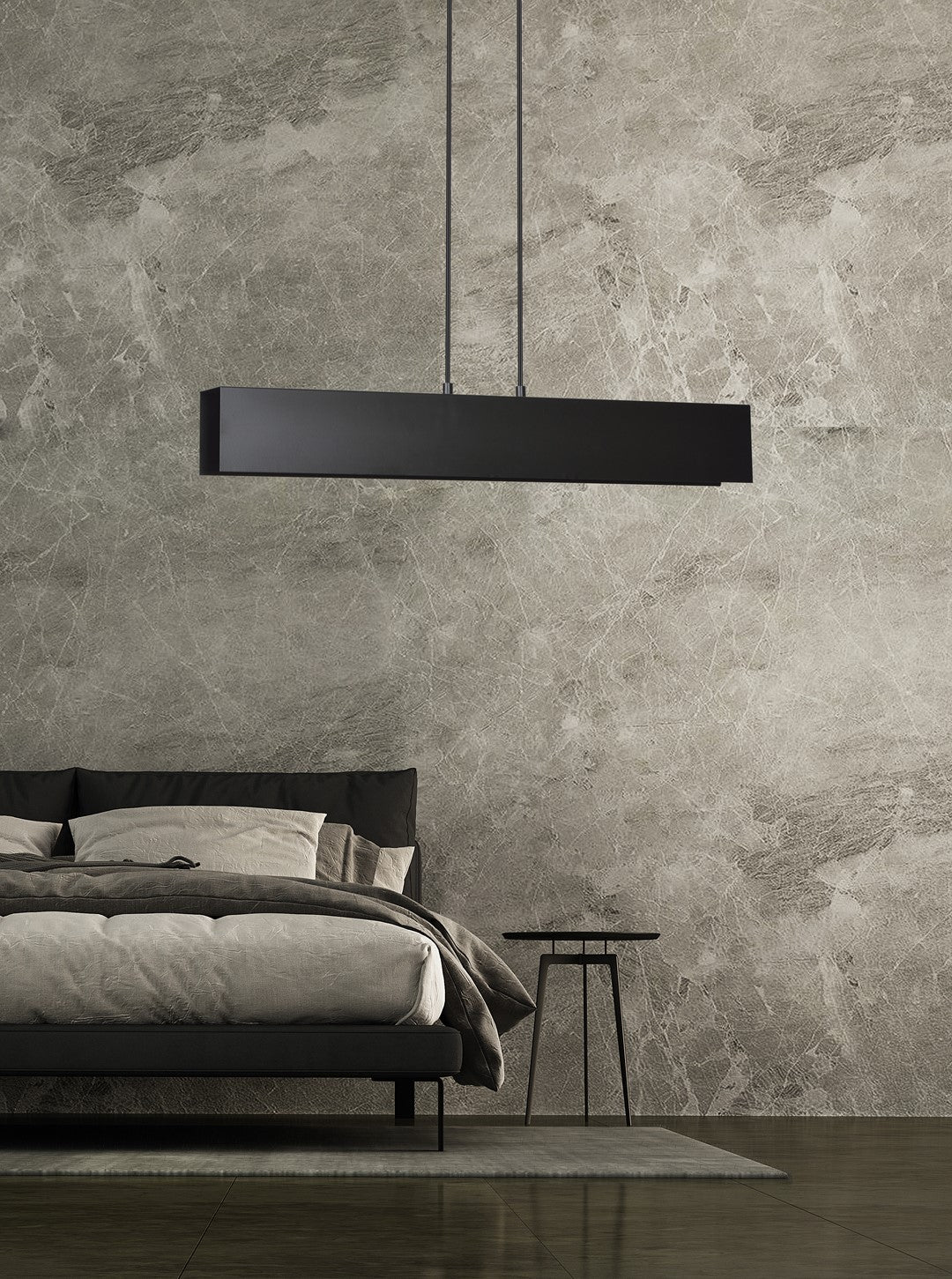 Mise en ambiance dans une chambre, luminaire noir suspendu au-dessus du lit