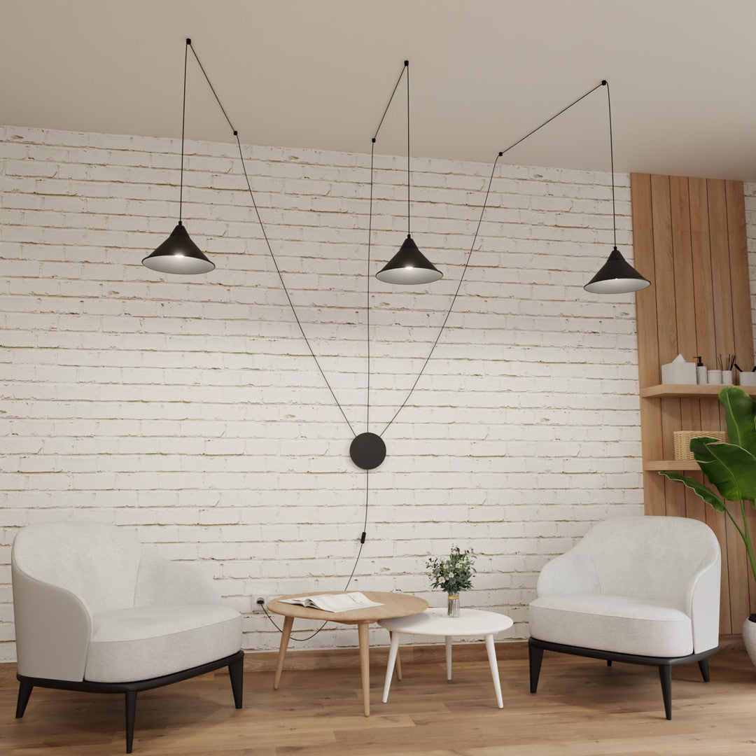 Suspension installée dans un salon, au-dessus d'une table basse, ambiance moderne.