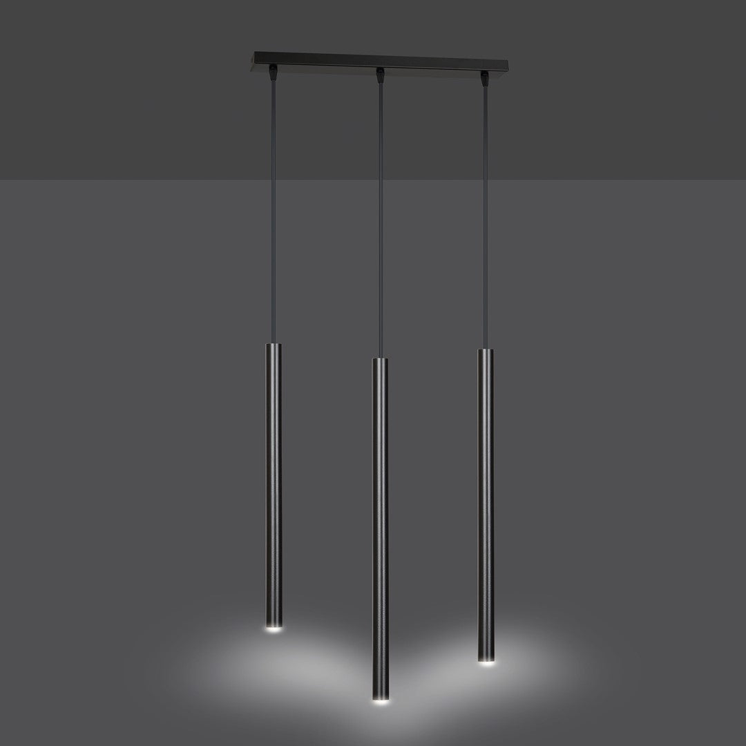 Vue en ambiance sombre où les trois tubes diffusent un halo lumineux