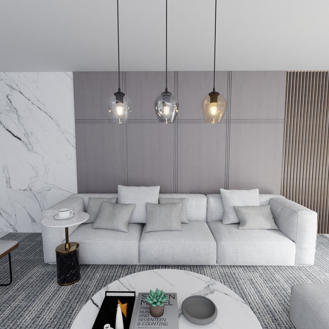 Luminaire allumé suspendu devant un canapé gris dans un salon moderne