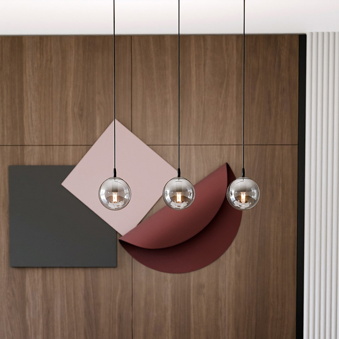 Détail des trois globes devant un panneau bois et des formes géométriques colorées