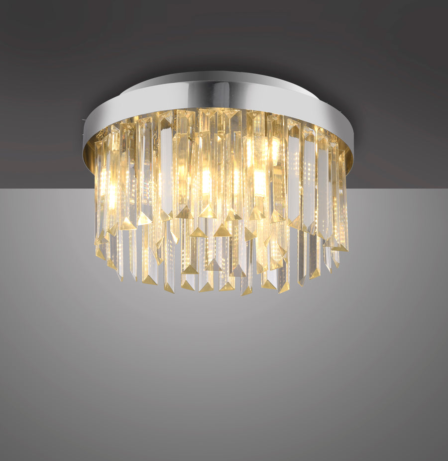 Vue de trois quarts du luminaire allumé sur fond gris dégradé