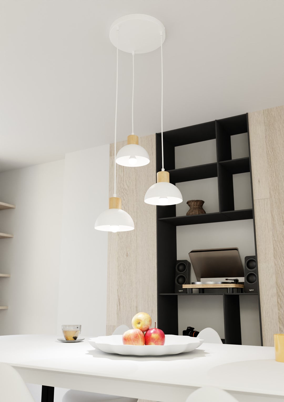 Suspension au-dessus d'une table blanche garnie de fruits, étagère noire en fond.