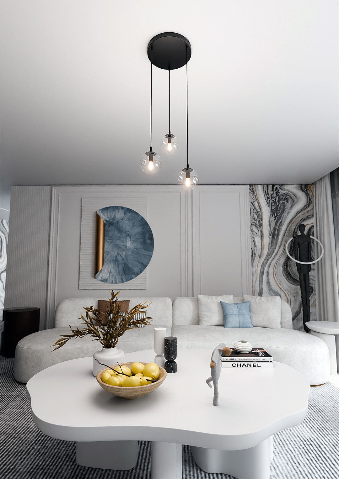 Mise en ambiance d'un salon avec canapé blanc, suspension allumée au-dessus de la table basse.