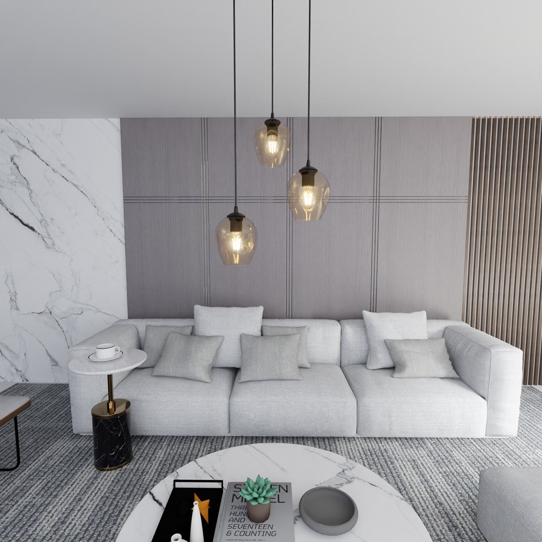 Les trois suspensions éclairent un salon contemporain avec canapé gris et décoration en marbre.
