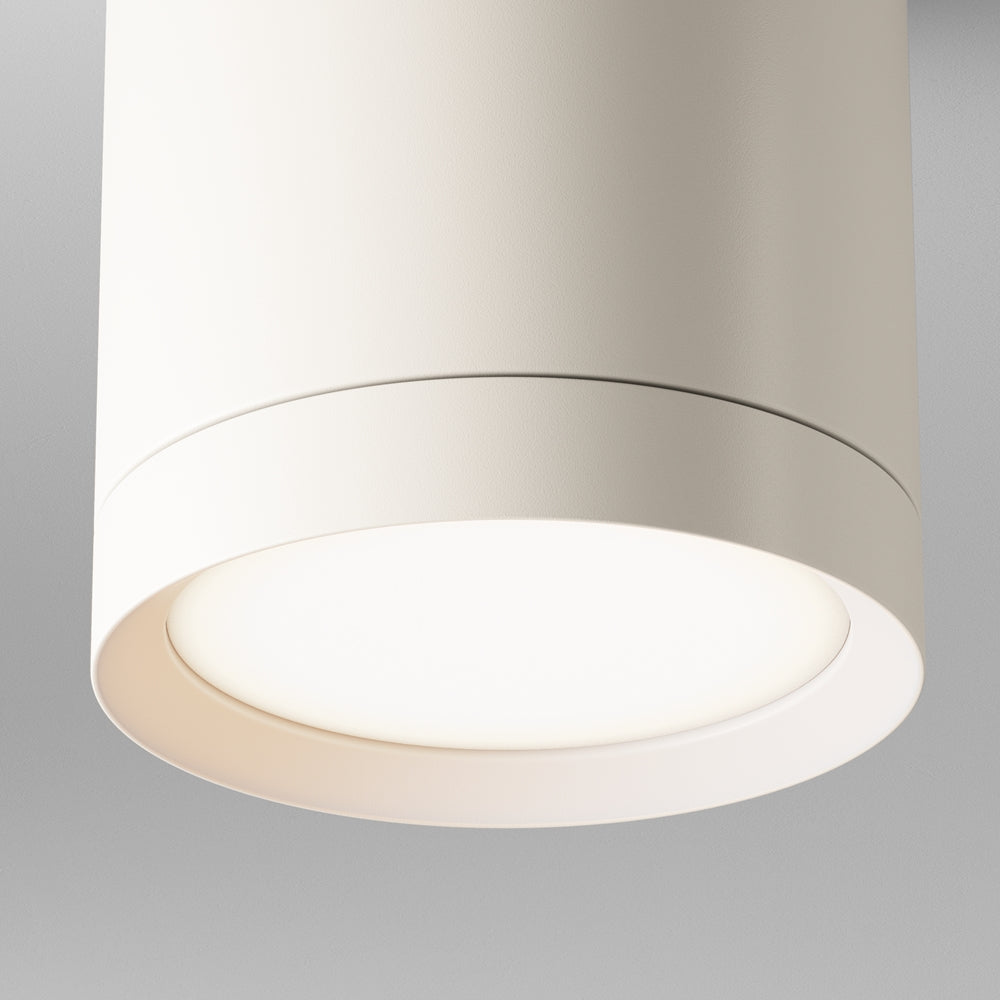 Gros plan du bas du cylindre et de son diffuseur lumineux blanc