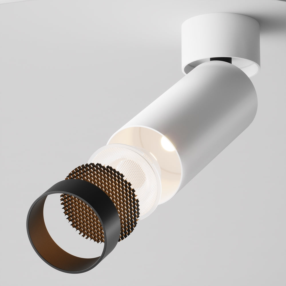 Vue éclatée du projecteur montrant déflecteur nid d'abeille et bague noire.