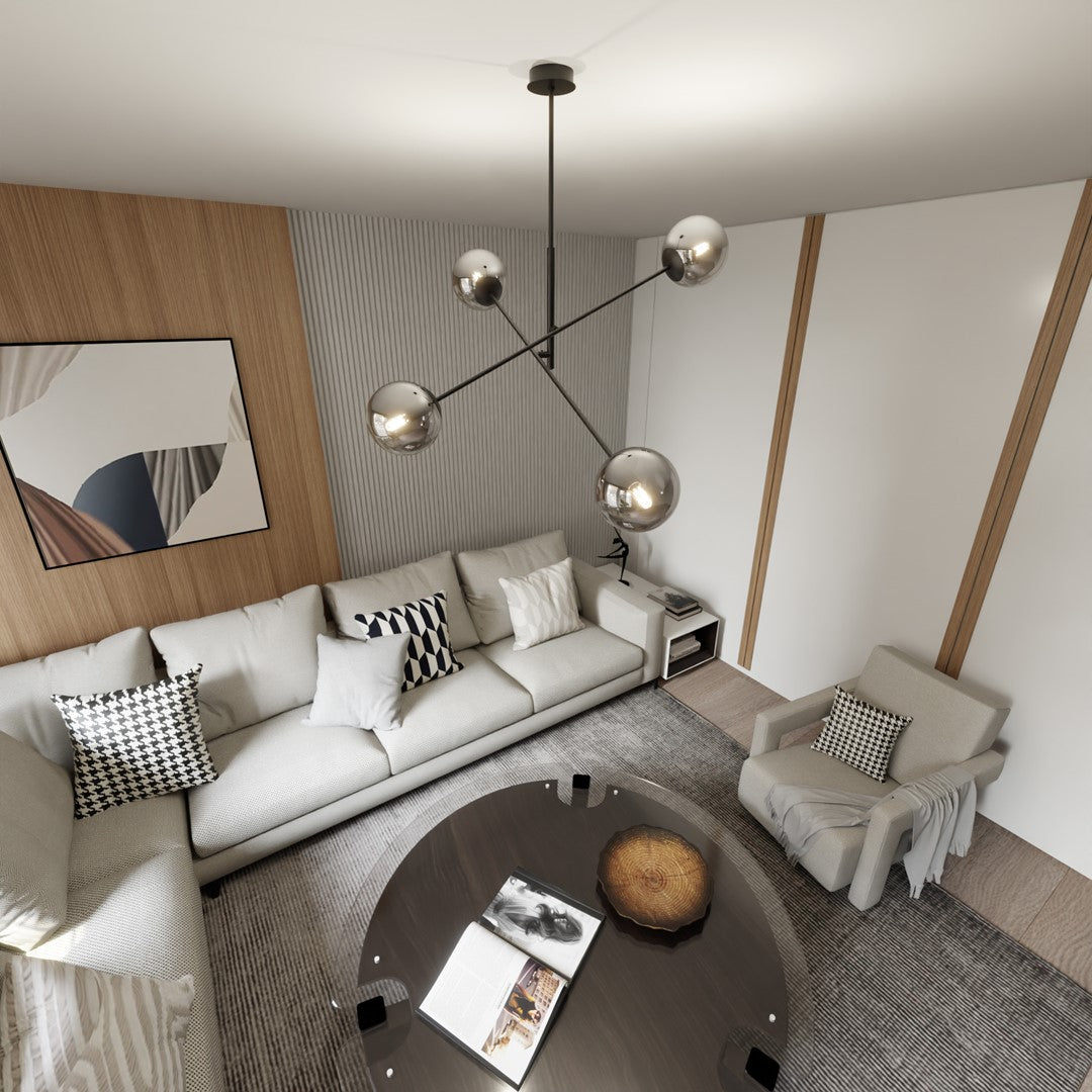 Mise en ambiance dans un salon moderne, suspension noire et globes graphites au-dessus du canapé.