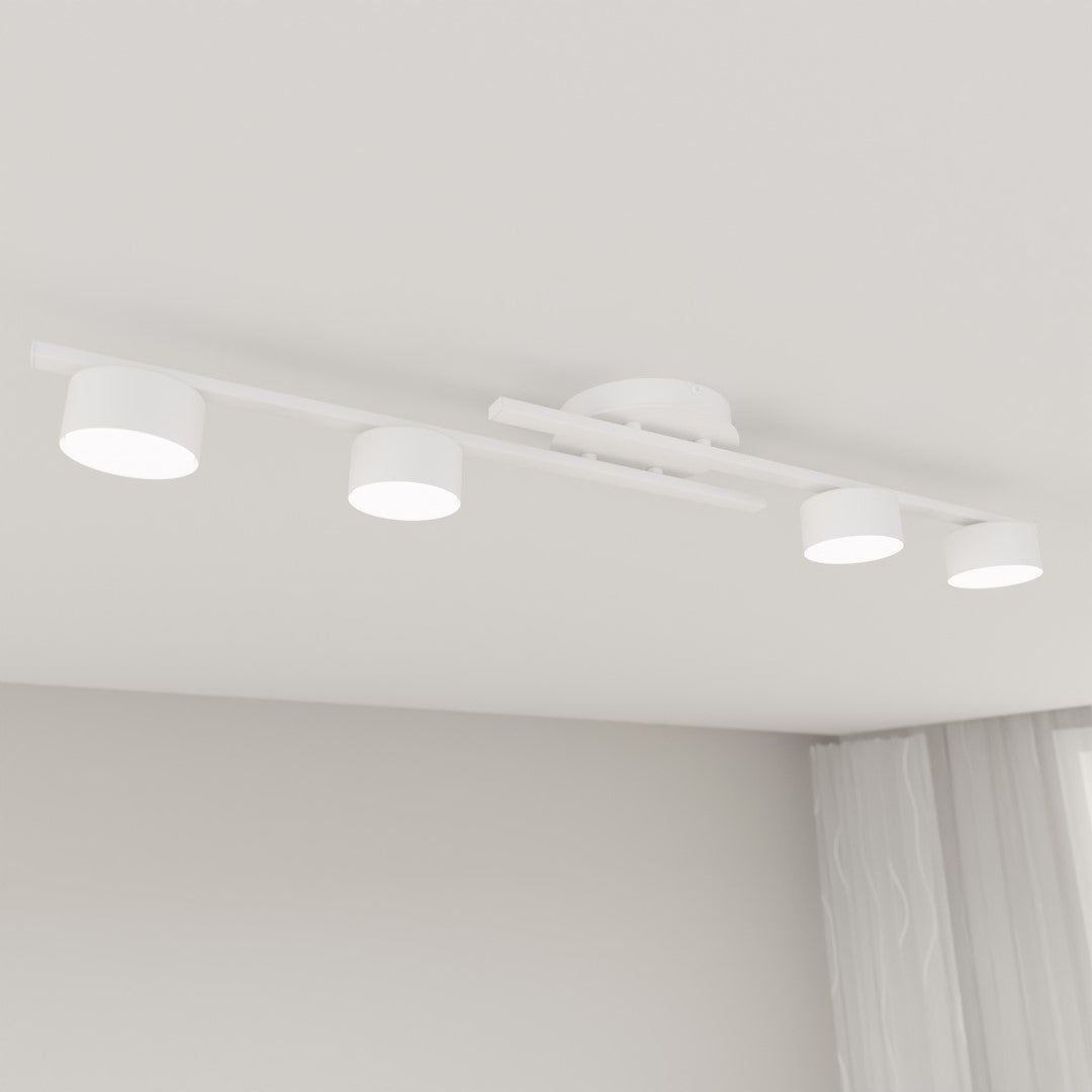 Luminaire vu en contre-plongée sous plafond, quatre diffuseurs ronds éclairés