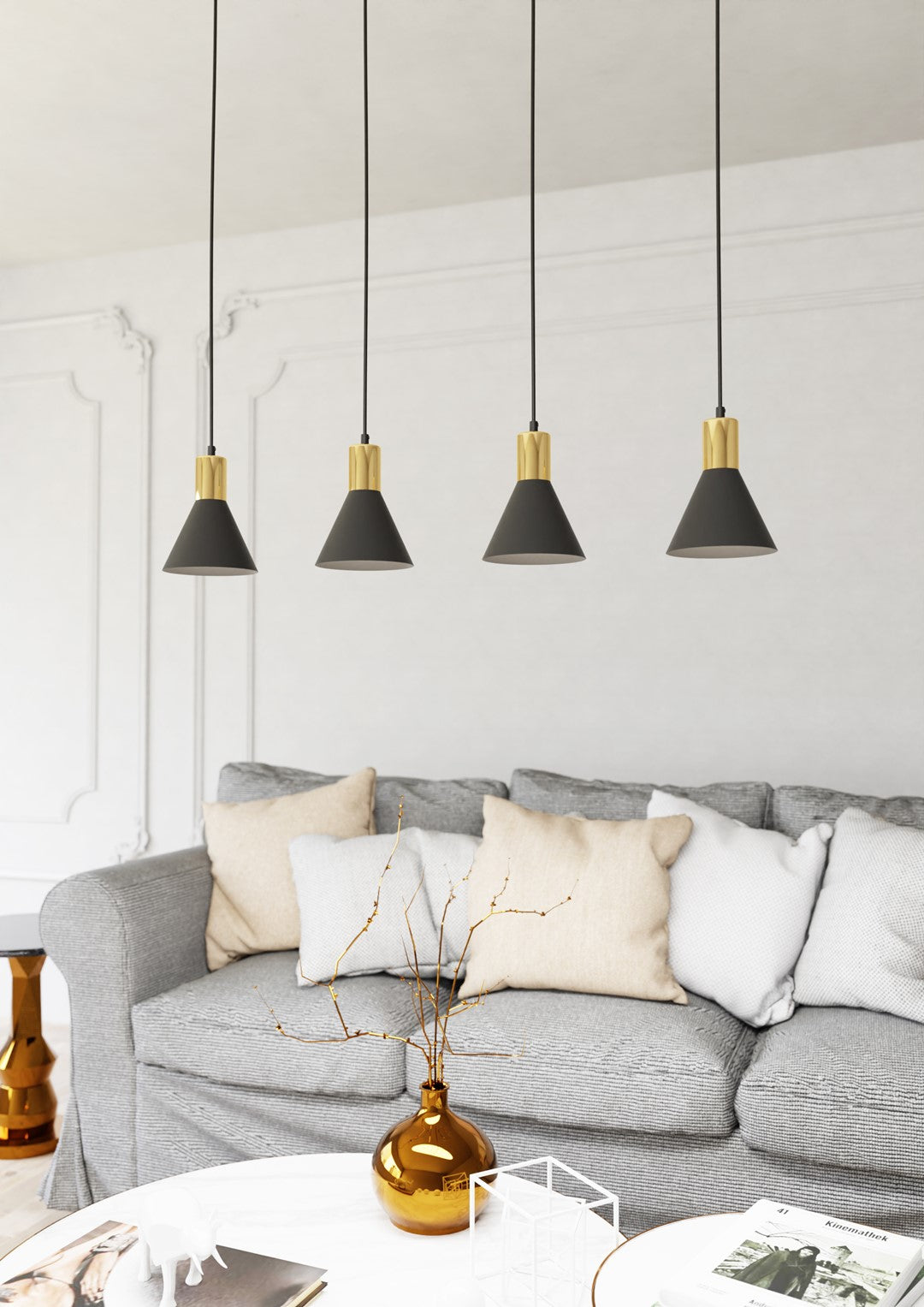 Suspension installée au-dessus d'un canapé gris dans un salon aux moulures blanches