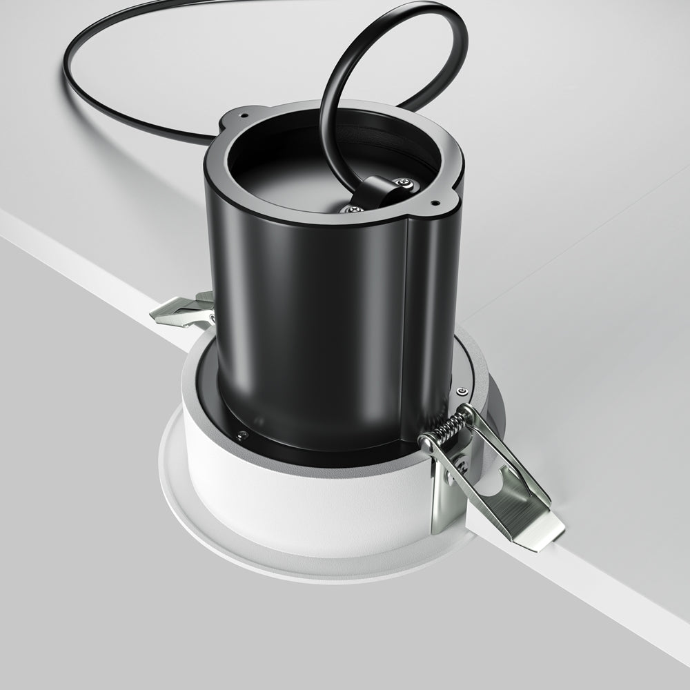 Produit hors plafond : corps noir, ressorts de fixation et câble d'alimentation