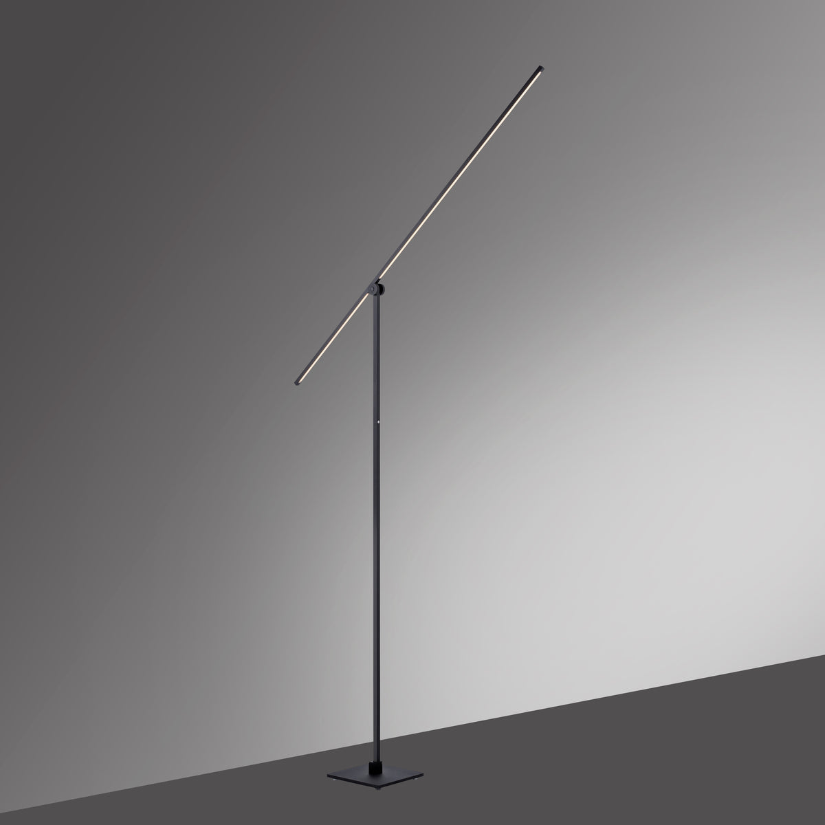 Lampadaire noir allumé sur fond gris dégradé, mettant en valeur la barre inclinée