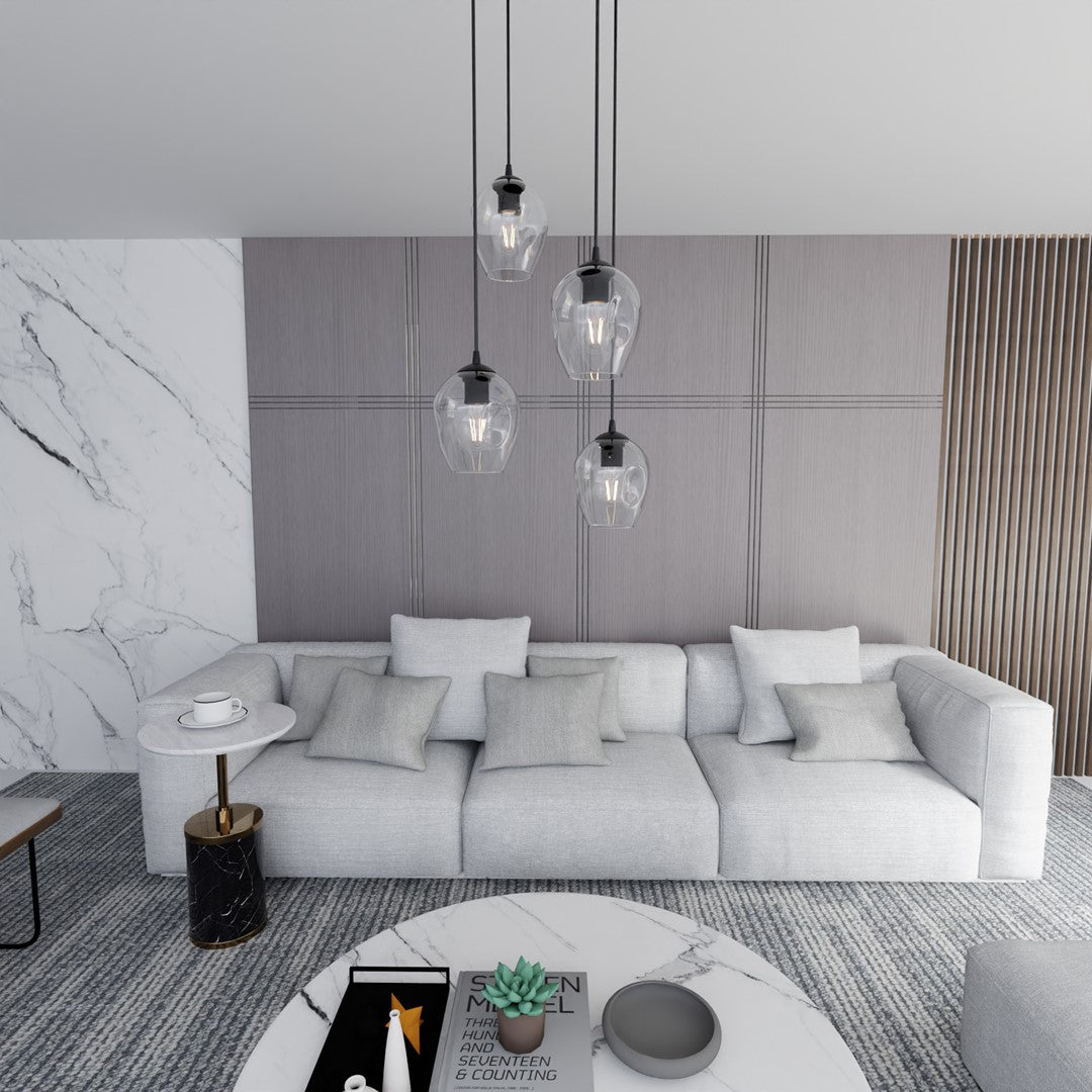 Ambiance salon, canapé gris clair et quatre suspensions en verre allumées en hauteur