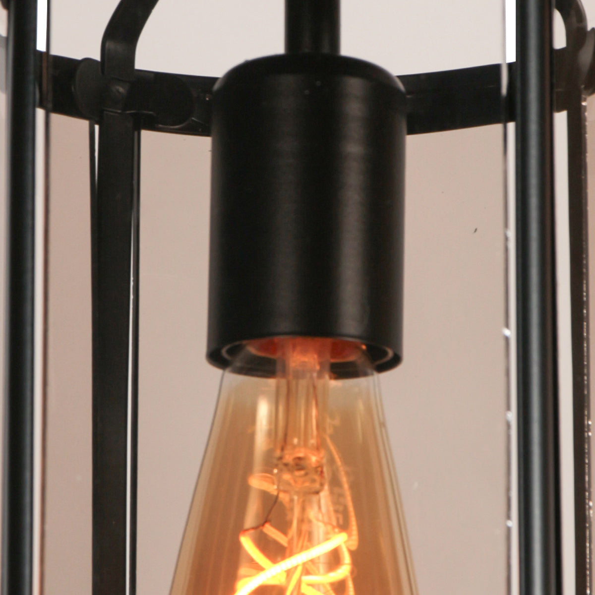 Détail rapproché de la douille noire et du culot de l'ampoule à filament