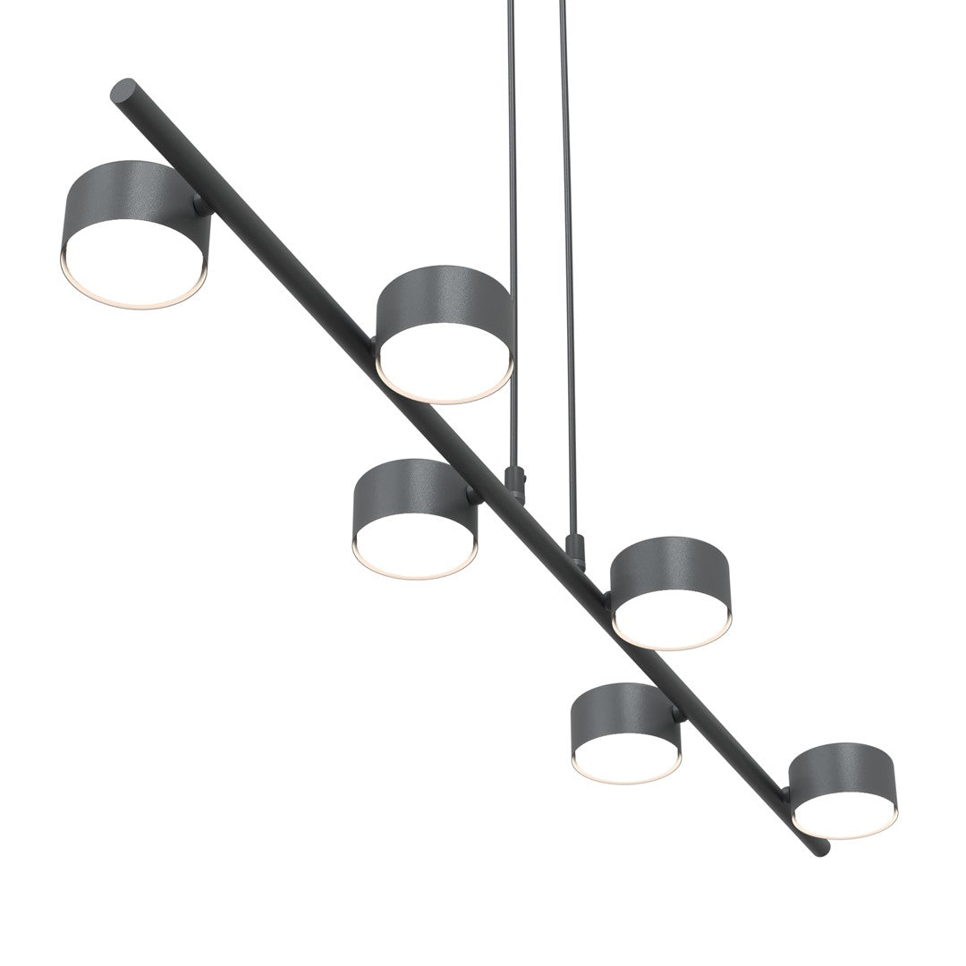 Gros plan sur les six diffuseurs ronds et le rail métallique noir du luminaire