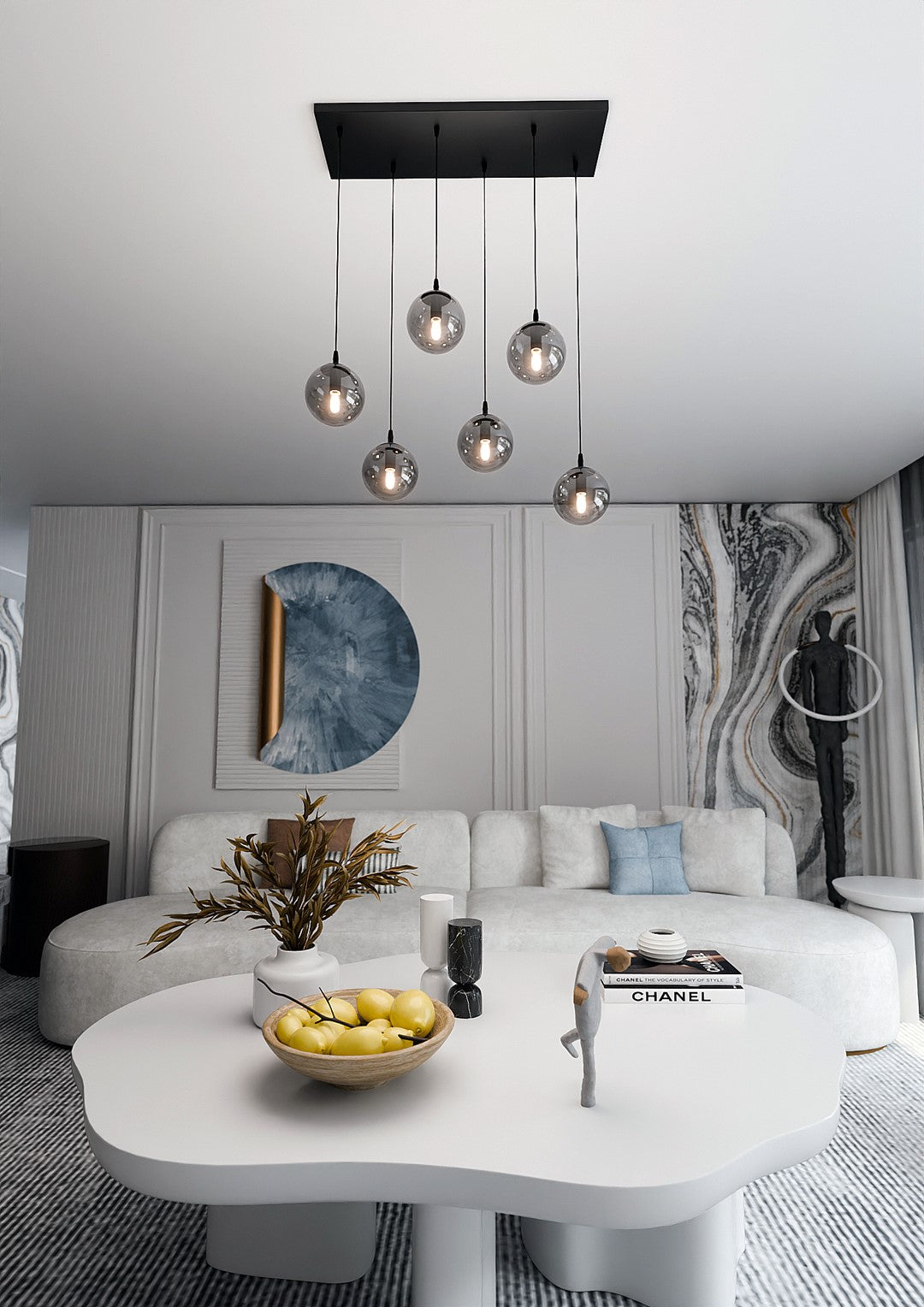 Mise en ambiance dans un salon moderne, suspension allumée au-dessus d'une table basse blanche