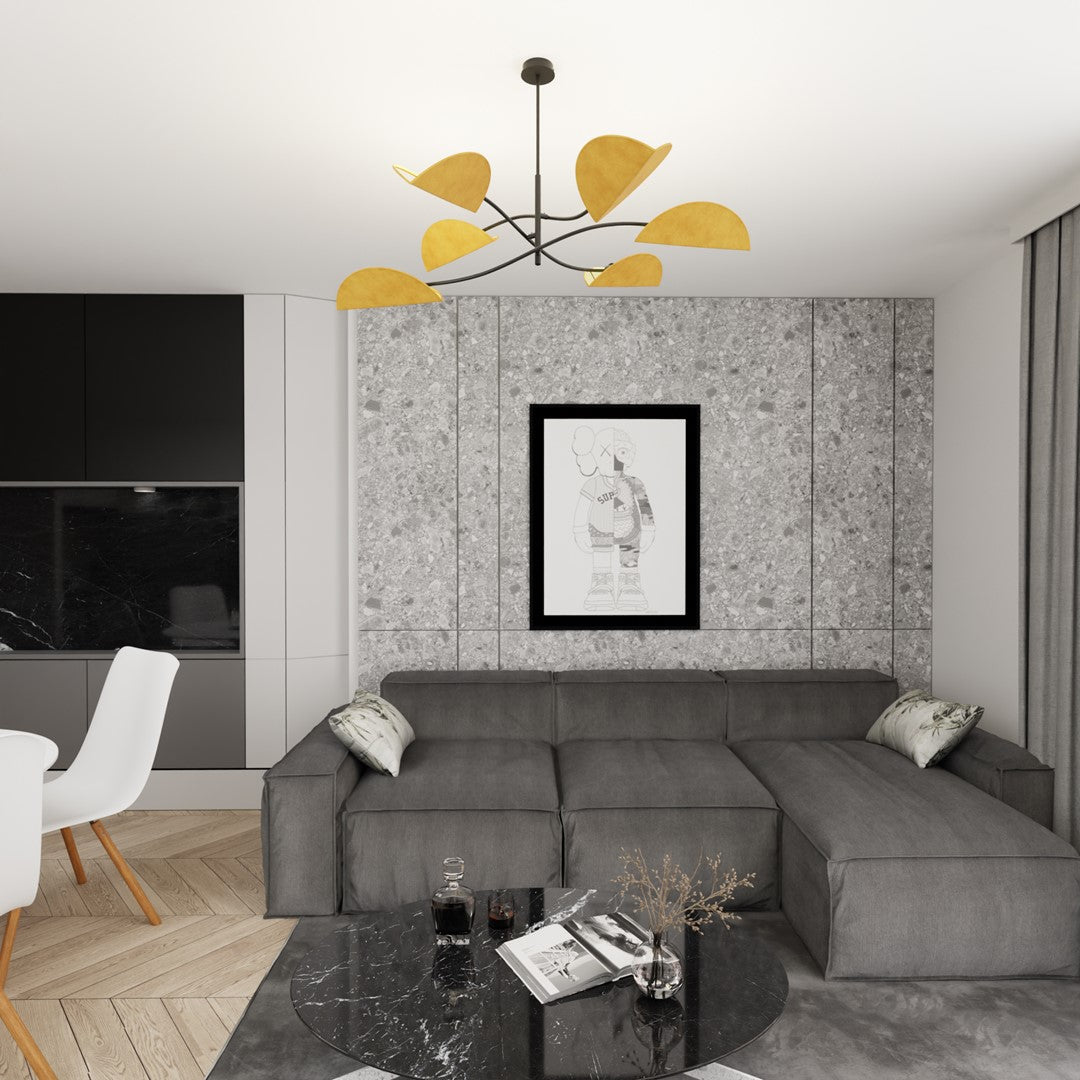 Suspension installée dans un salon gris, mur en pierre reconstituée et canapé d'angle
