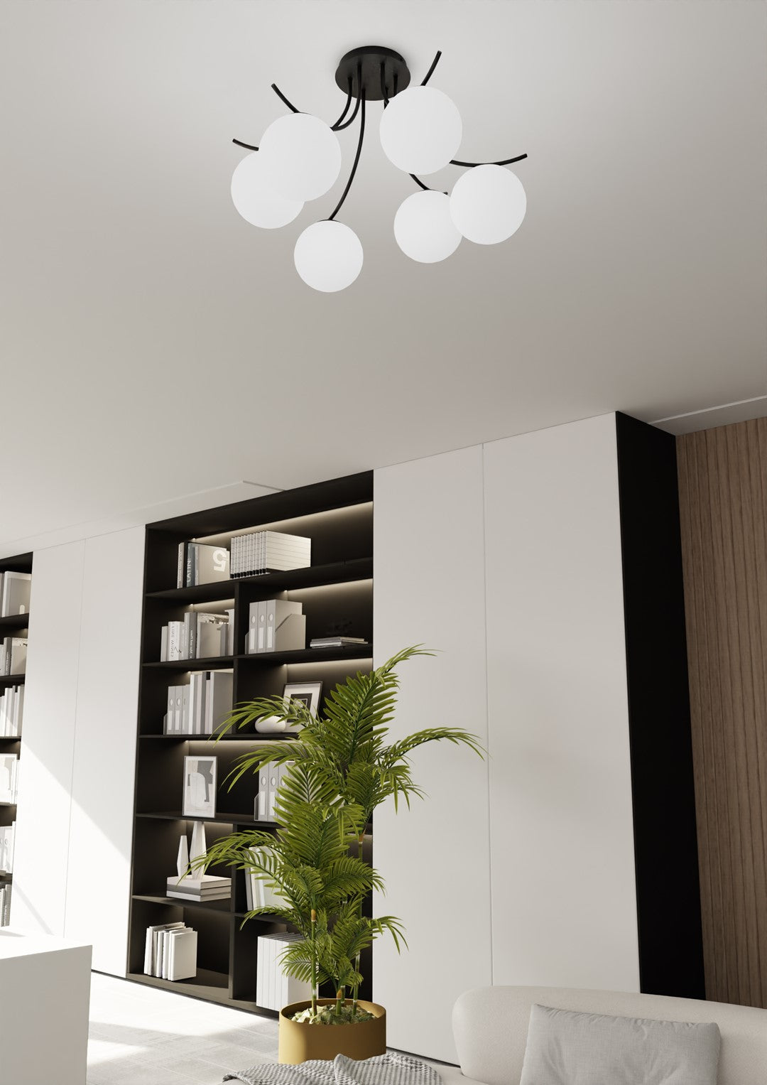 Plafonnier fixé au plafond, intérieur avec bibliothèque noire et palmier en pot.