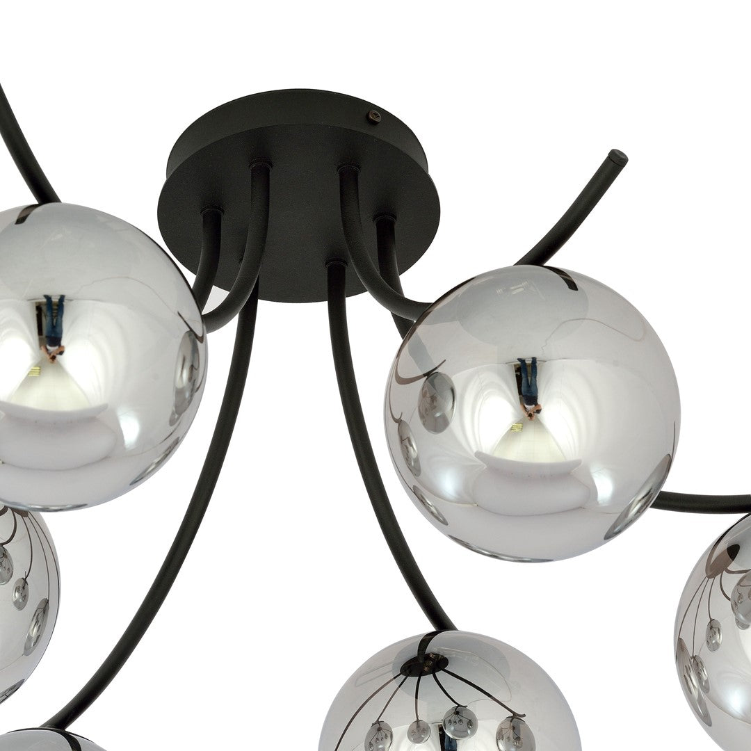 Détail du socle noir et des bras métalliques courbes supportant les globes de verre