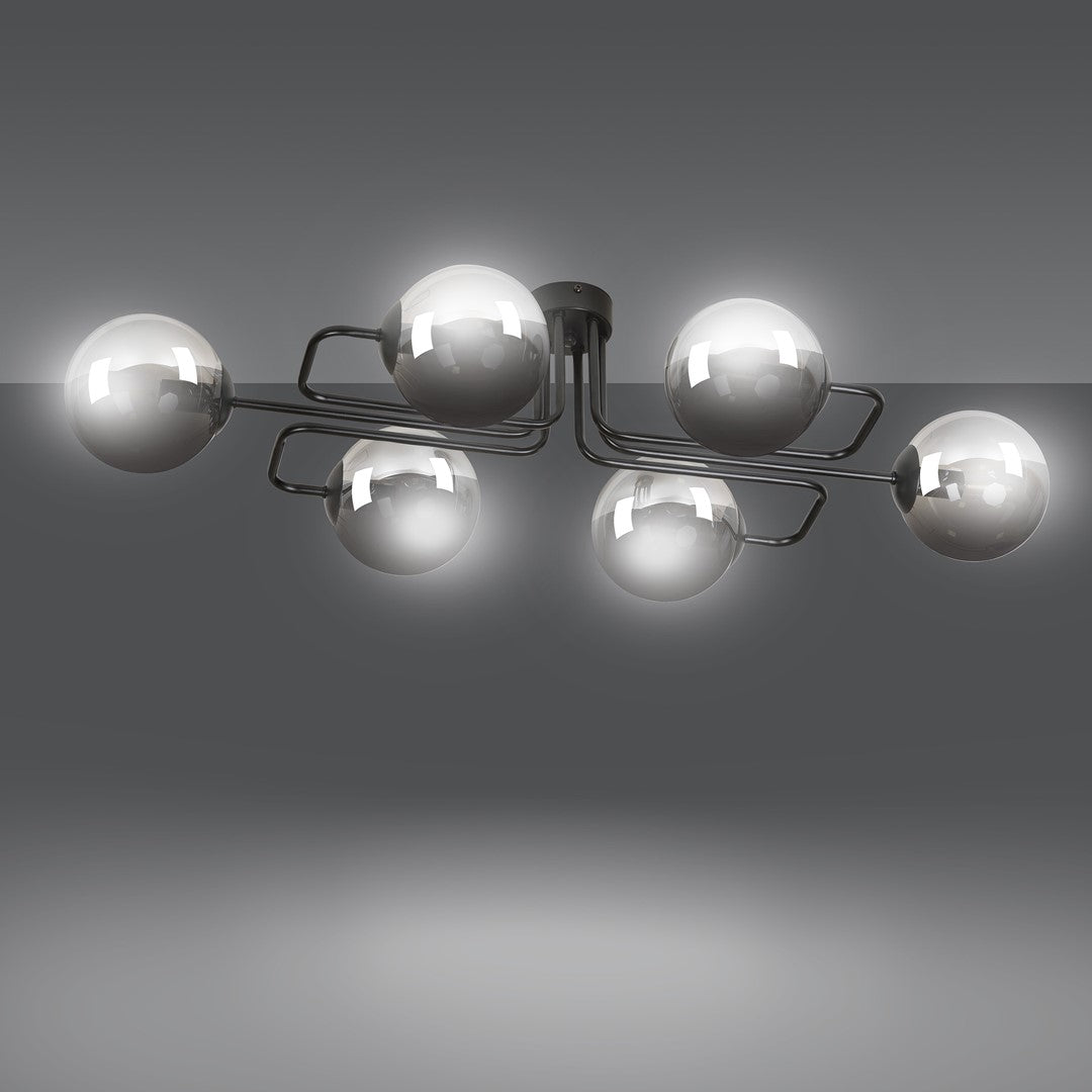 Luminaire allumé sur fond gris, halos lumineux autour des globes