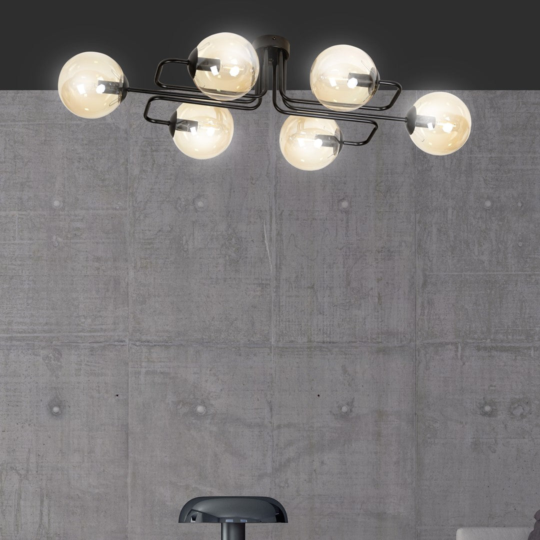 Gros plan des six globes lumineux devant une paroi de béton gris