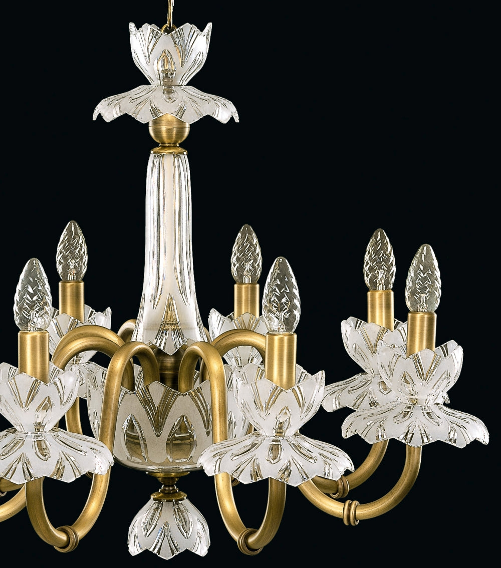 Gros plan sur la colonne centrale en cristal et les bras dorés du lustre
