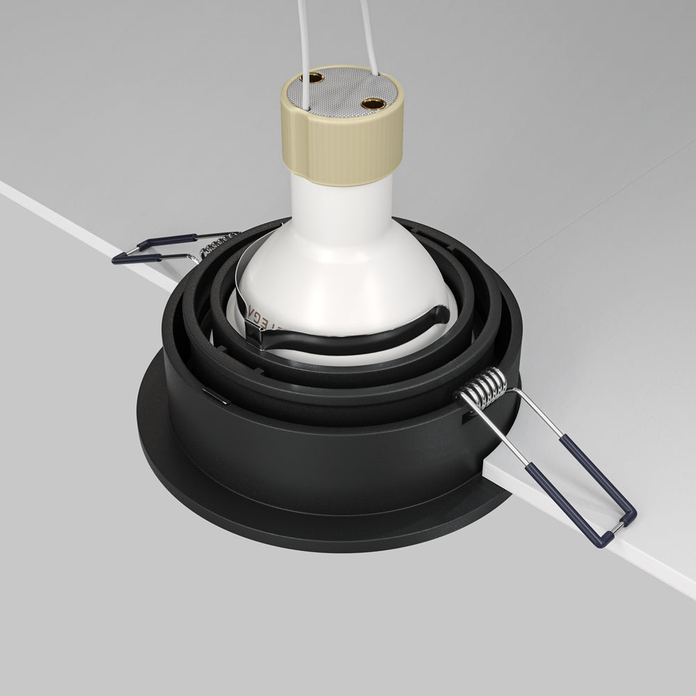 Vue arrière du spot noir avec ressorts de fixation et module LED blanc.