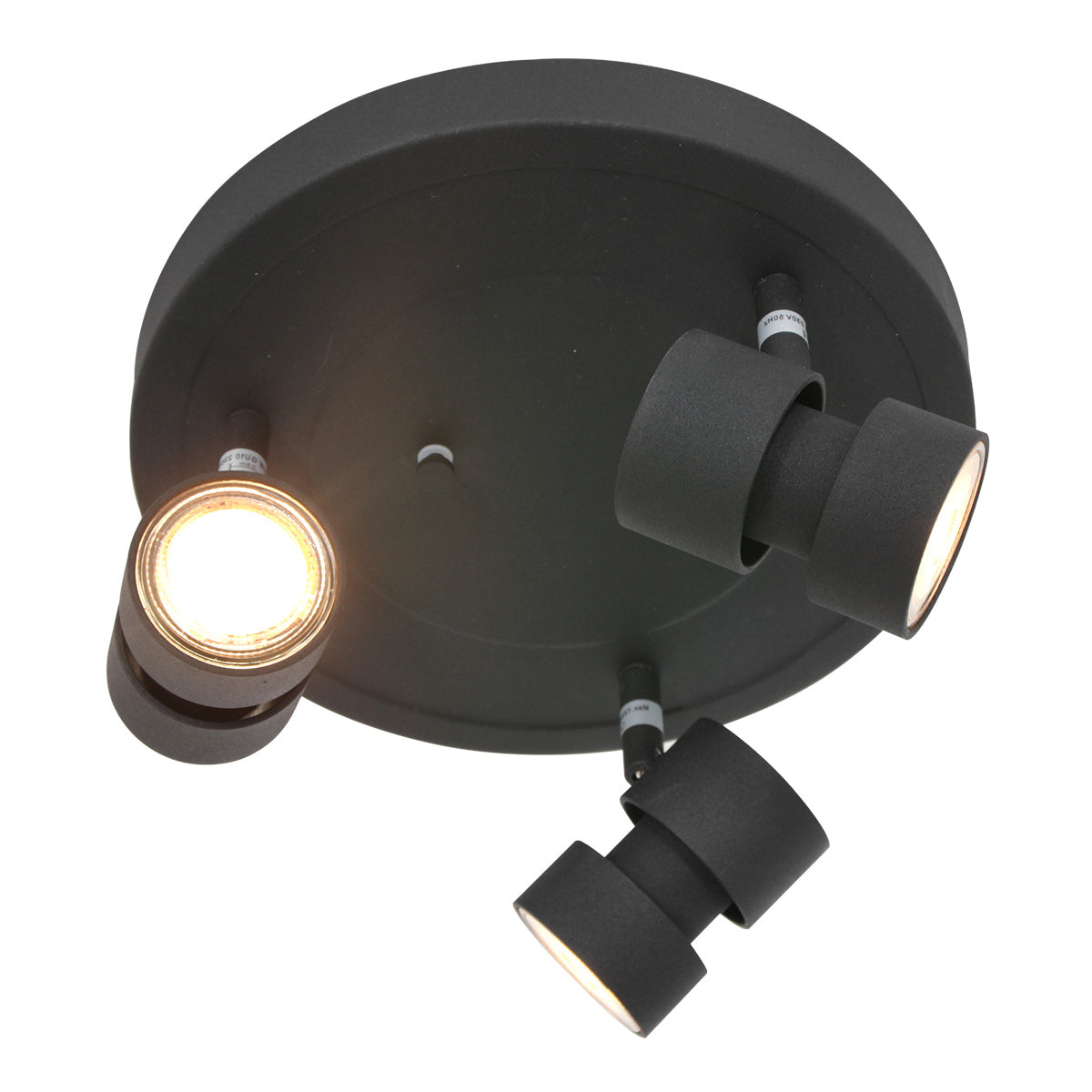 Trois projecteurs cylindriques noirs dont un allumé en lumière chaude
