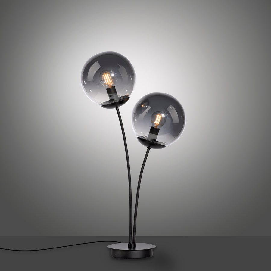 Vue de trois quarts avec câble apparent, lampe allumée sur fond dégradé