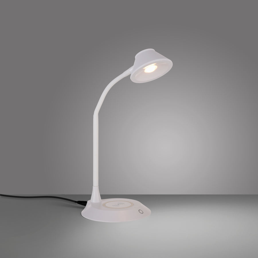 Vue de profil de la lampe allumée sur fond gris, socle et câble visibles.