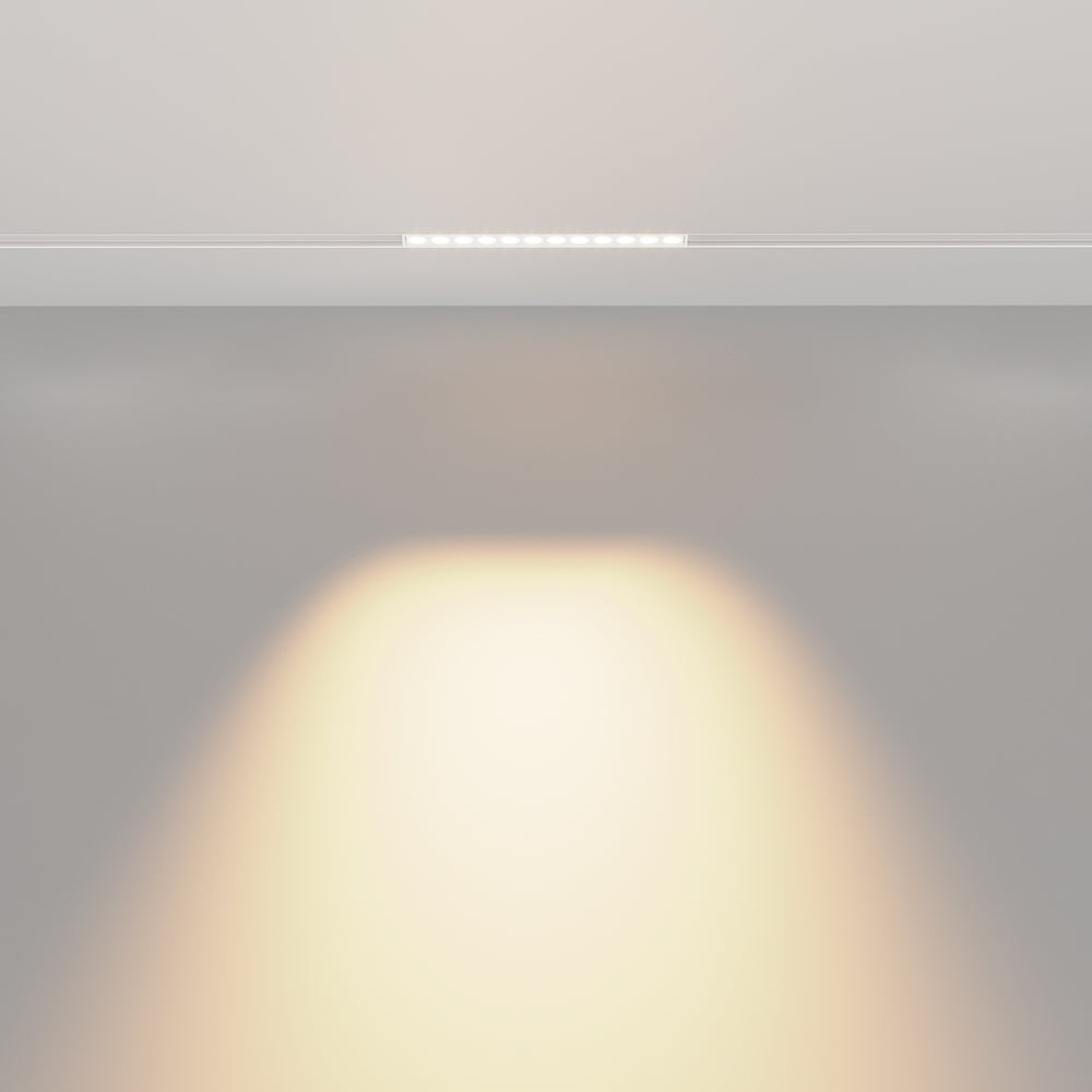 Mise en ambiance : halo lumineux diffus projeté sur le mur sous le luminaire encastré