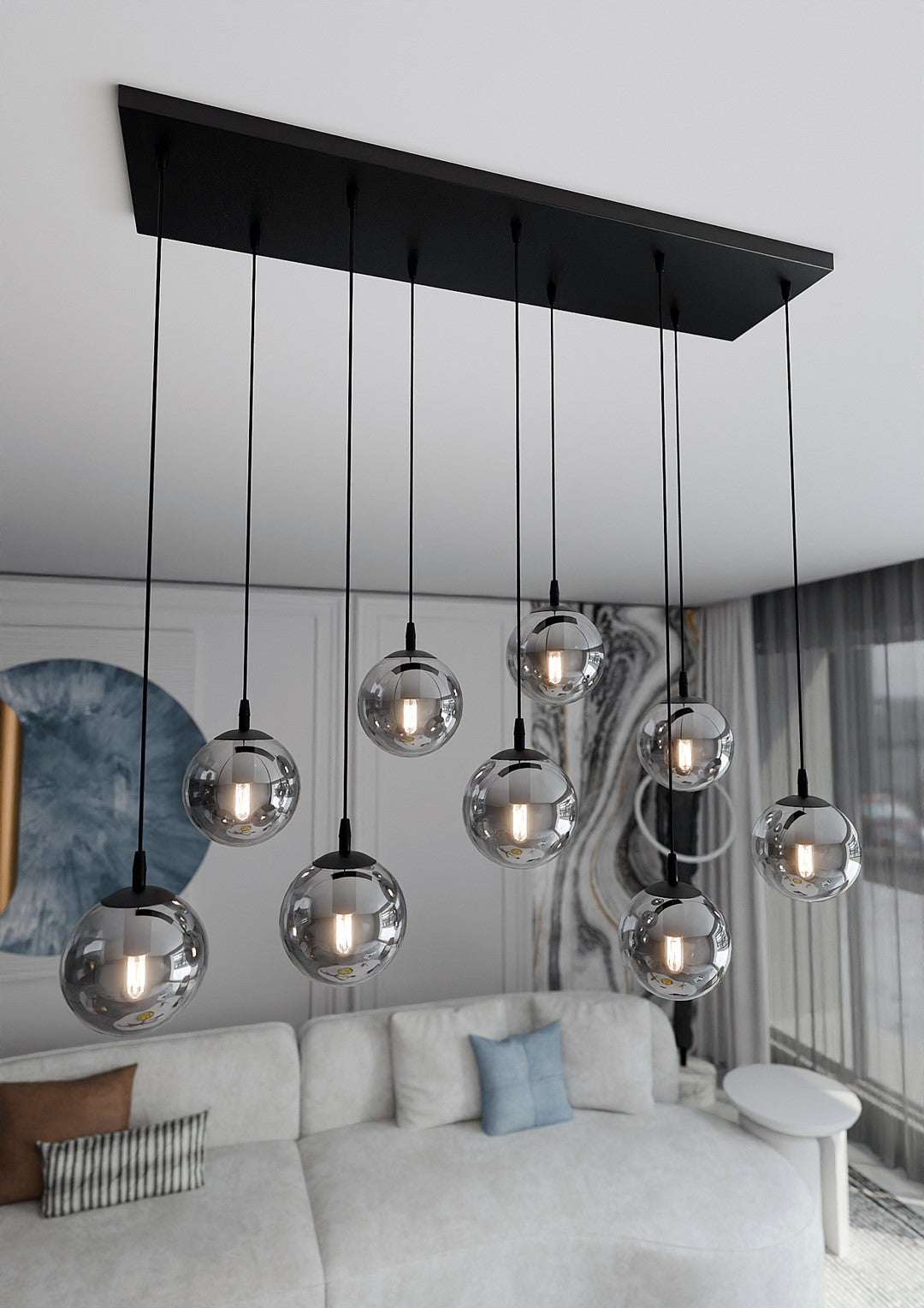 Vue en enfilade du salon avec le luminaire suspendu au plafond blanc et canapé.