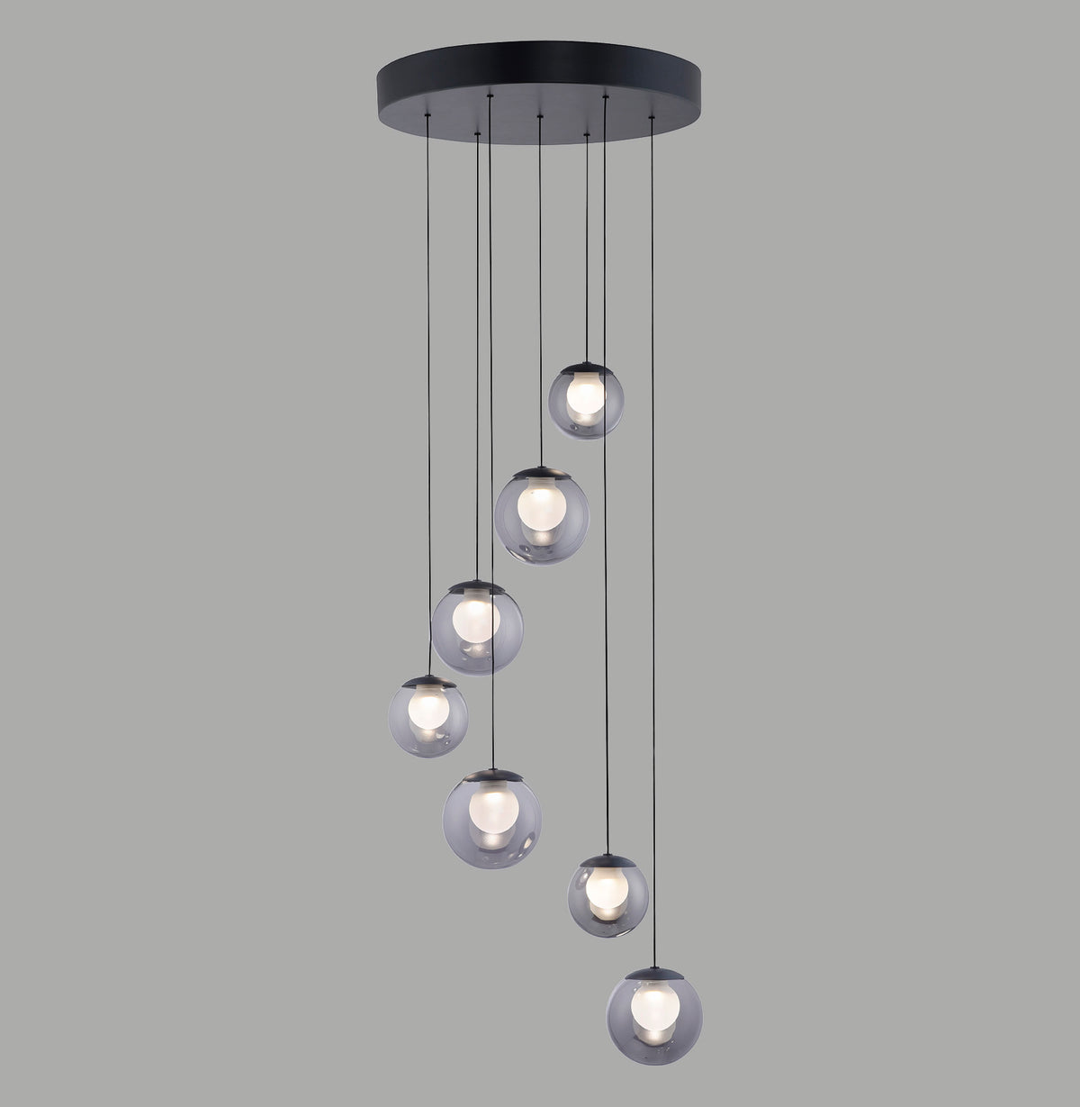 Vue de face du luminaire suspendu : sept boules en verre fumé sur câbles noirs.