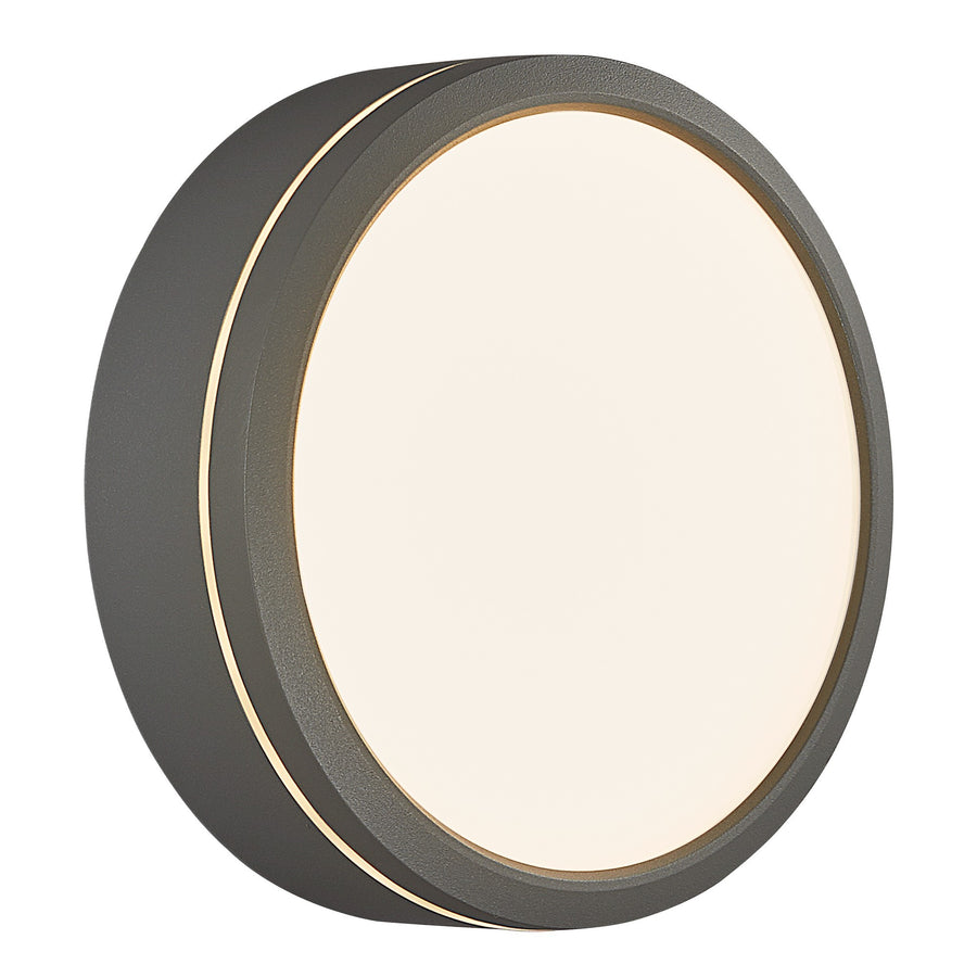 Luminaire extérieur rond gris incliné, demi-sphère inférieure allumée et bord doré visible