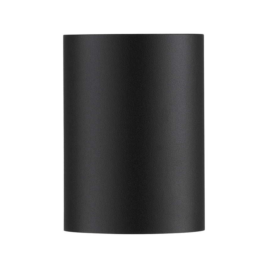 Vue de face de l'applique noire, surface mate et arrondie, fond neutre uniforme.