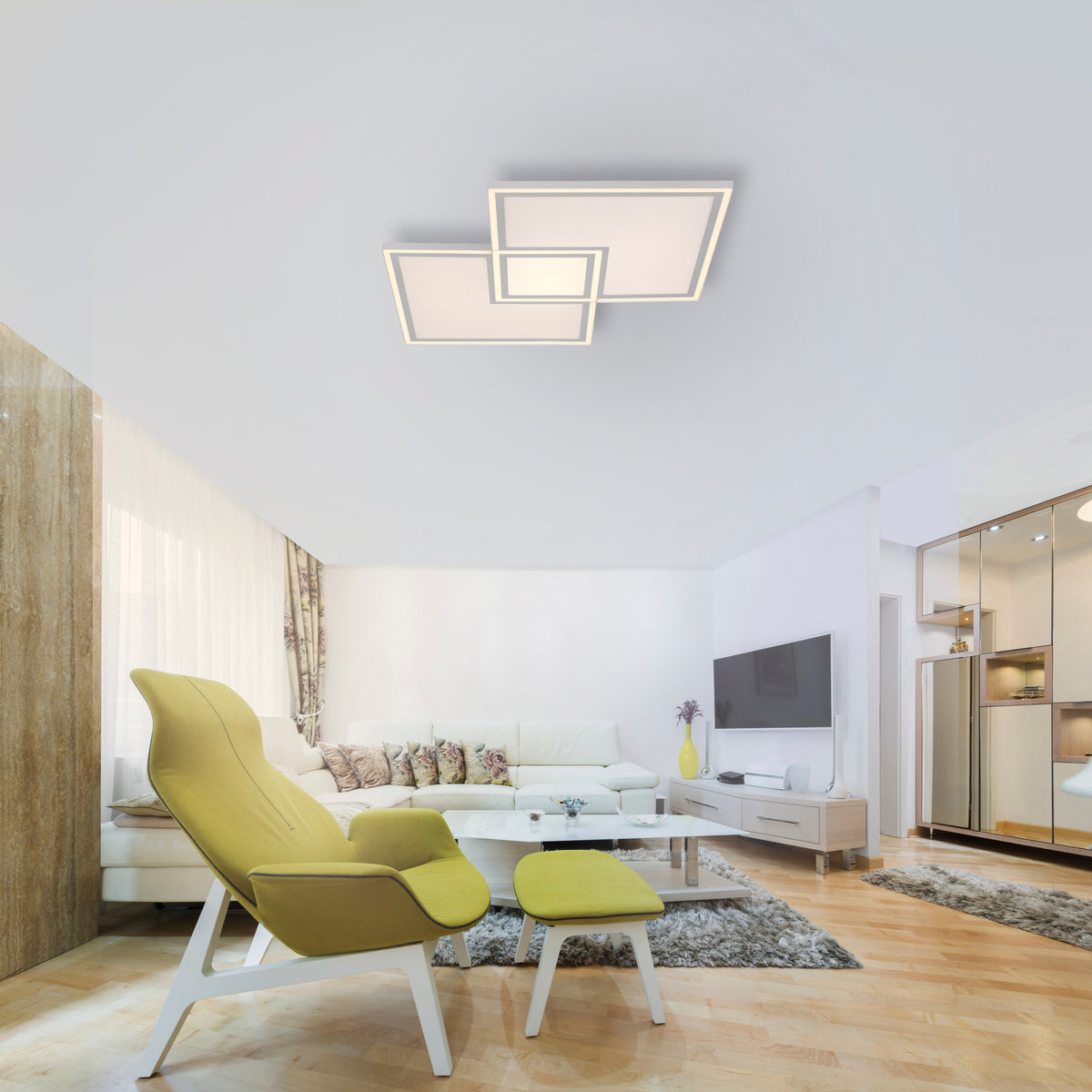 Mise en ambiance dans un salon moderne : plafonnier blanc allumé au plafond.