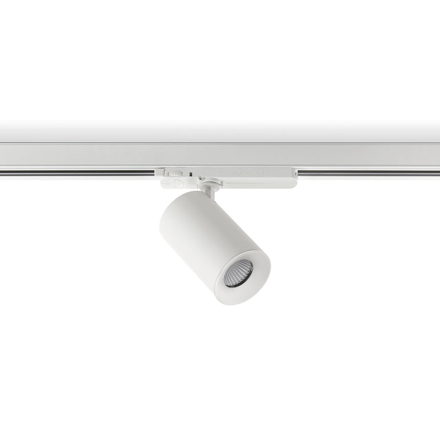 Spot blanc sur rail, corps cylindrique incliné, LED visible de trois quarts.