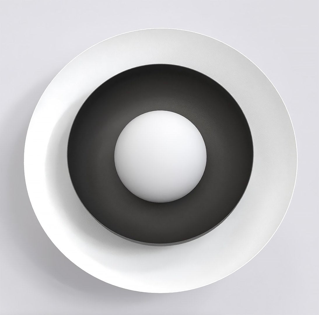 Vue de face montrant le disque blanc, le cône noir et la sphère centrale.